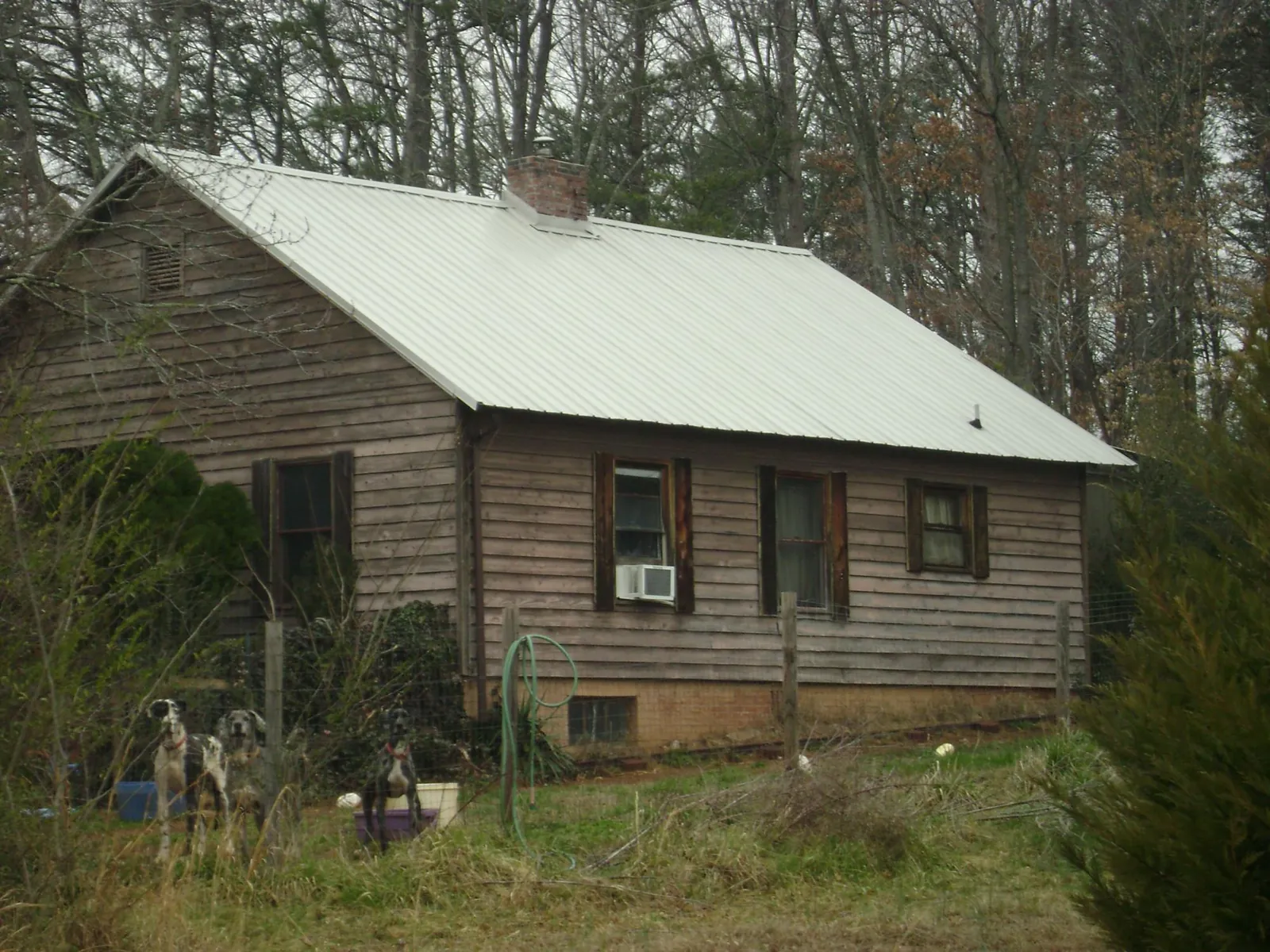 White metal roof on an old wood sided farmhouse, from a Metal Roof Installation job in Spotsylvania